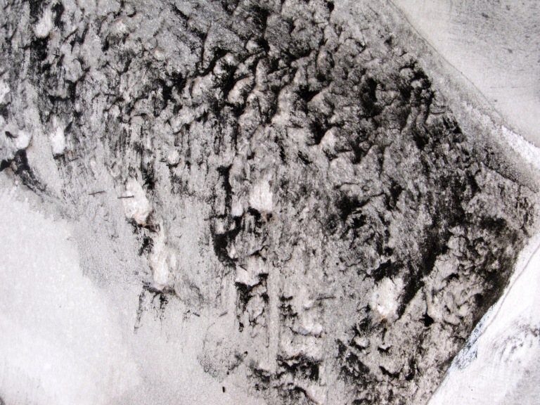 close-up of a scratched surface made with ink and charcoal on paper